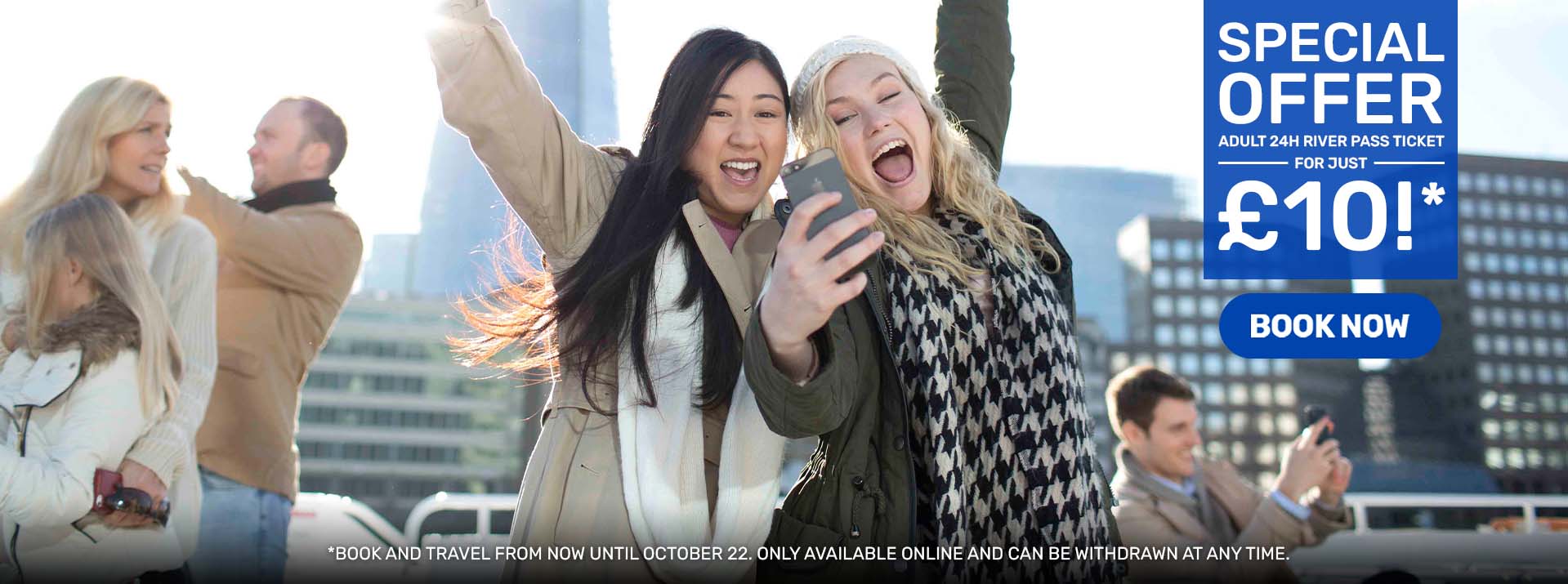 2021_297248_CC_UK_HERO-Upsell Sightseeing-Final (1) Two women taking a selfie with a cityscape and people in the background.