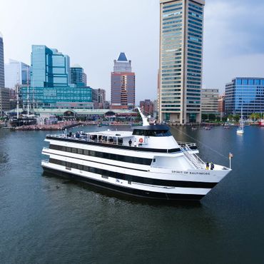 Large yacht in Baltimore with city background.