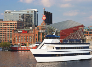 Yacht with Baltimore skyline in background.