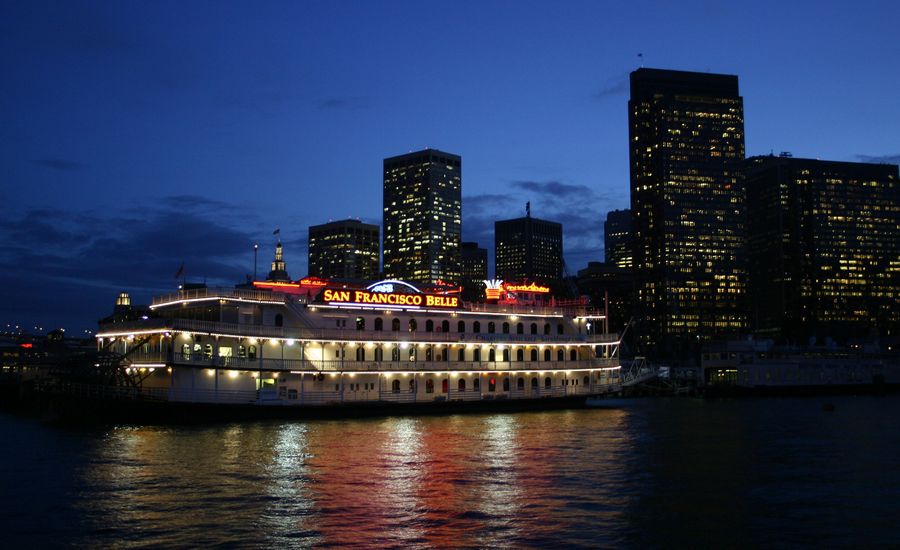 San Francisco Belle paddle wheel boat lit up at night.