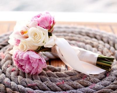 Coiled rope with bouquet of flowers in middle