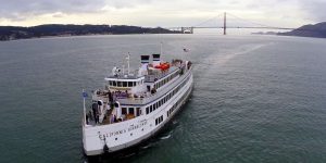 Yacht in San Francisco Bay Golden Gate Bridge in distance.