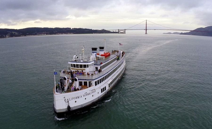 Yacht in San Francisco Bay Golden Gate Bridge in distance.