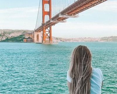 Woman looking out at the water and Golden Gate Bridge.