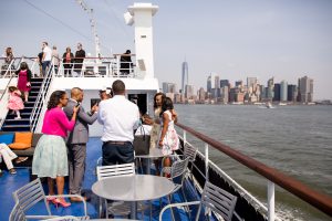 People on the deck of a boat taking pictures