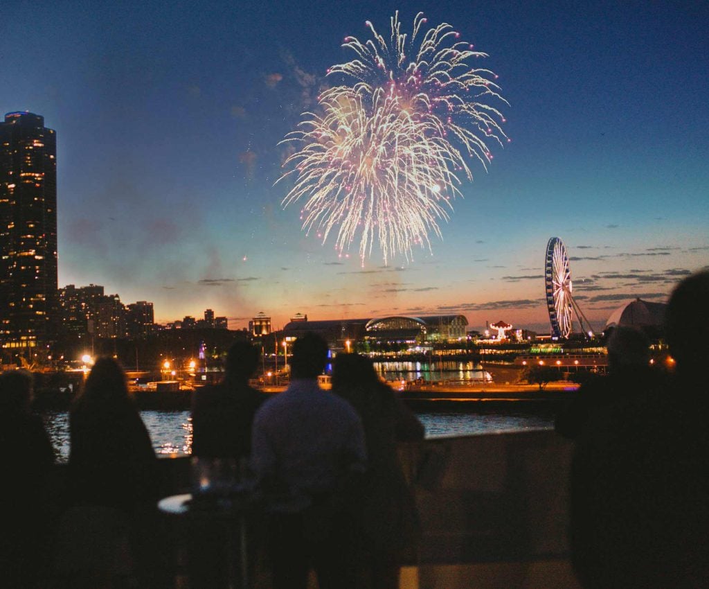 Chicago fireworks at night from the water.