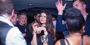 A group of people dancing at a party.