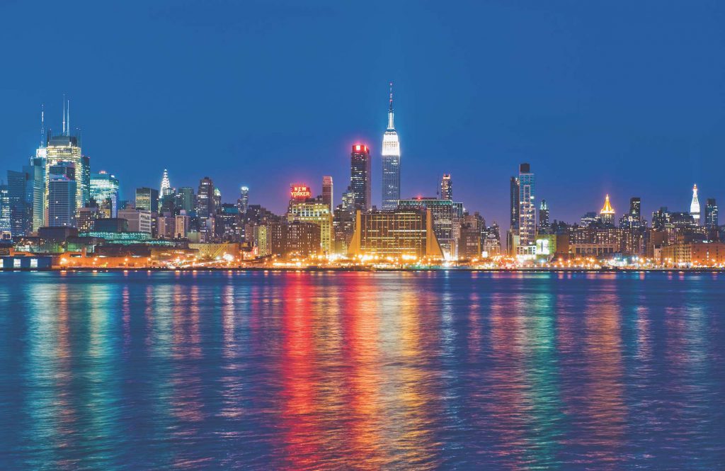 New York City skyline lights reflecting on water
