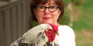 Regina Charboneau holding a chicken.