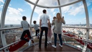 A family in the London Eye facing the city skyline