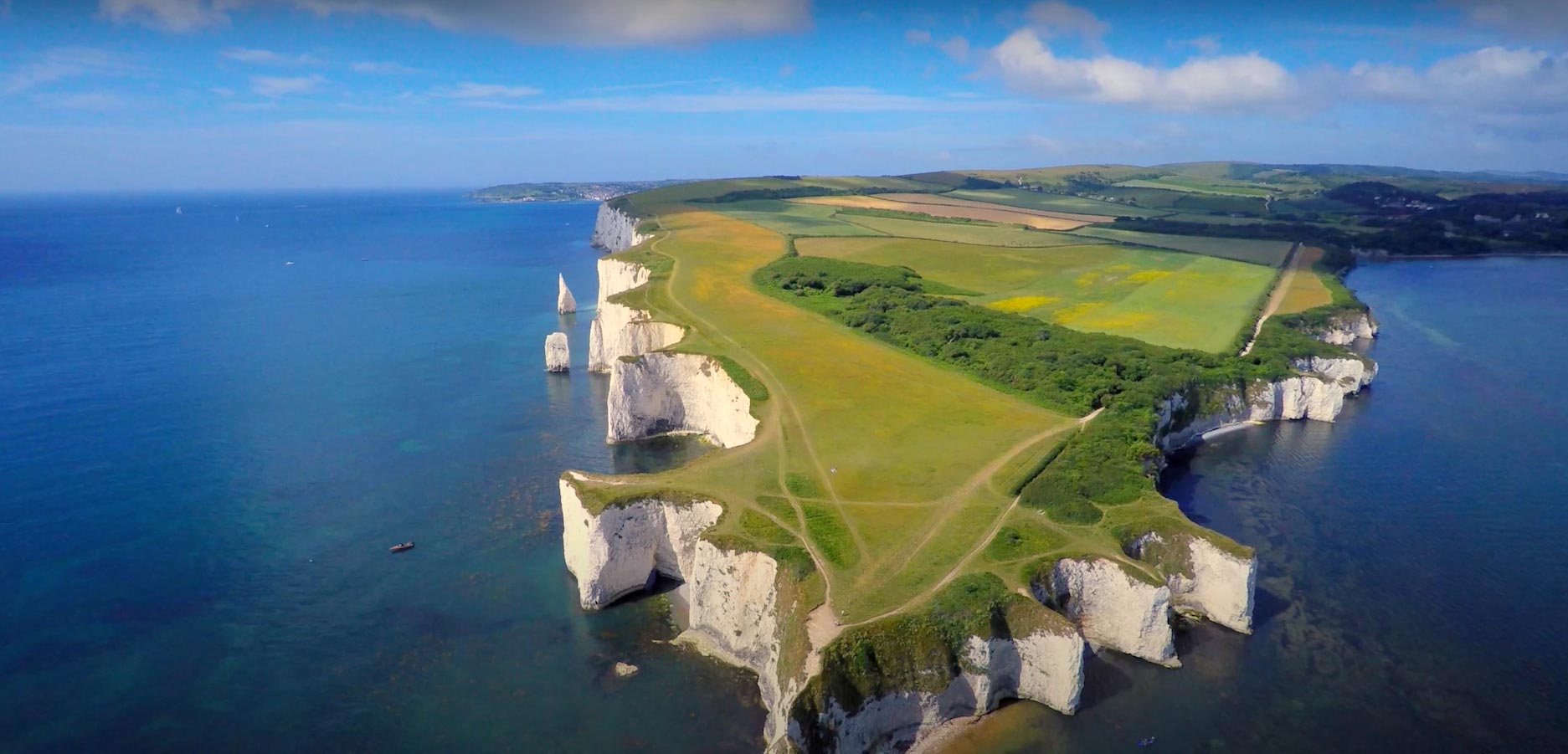 Poole white cliffs with green grass covering them.