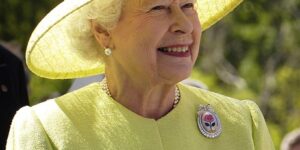 Rainha Elizabeth em amarelo com um chapéu amarelo.
