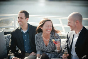 People on a boat holding drinks.