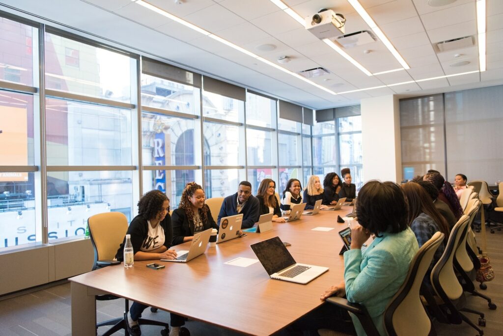 Large office desk with people sitting around it