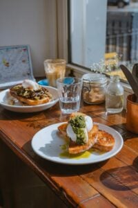 Breakfast plates with food set at a window table