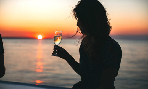 Drinking wine with sunset in background