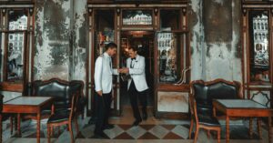 A Venice restaurant with two waiters in front wearing white jackets