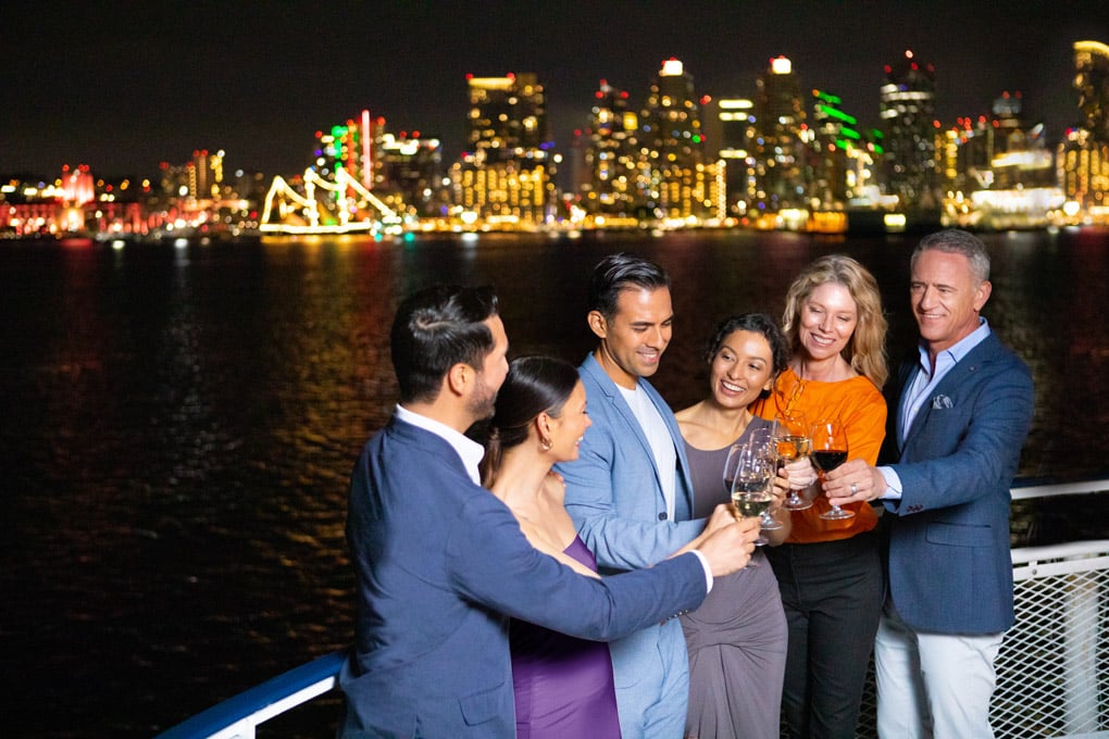 group on a cruise with san diego skyline in background