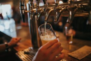 A beer tap with a beer glass being filled