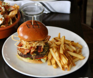 Hamburger on a plate with French fries