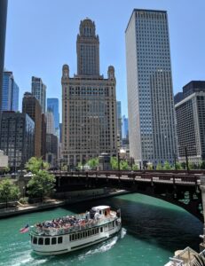 Chicago River with boat going under a bridge