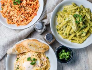 Three plated pasta dishes