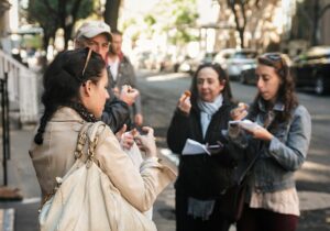 People tasting food on a city street