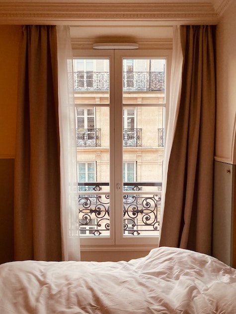 Hotel room view through window to neighboring building