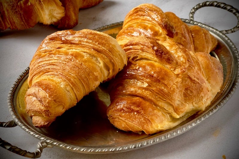 Two croissants on a silver tray