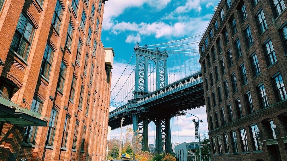 View of Manhattan Bridge between two buildings