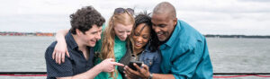 group looking at phone corporate event