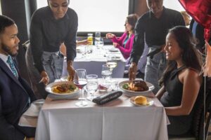 A couple eating being served their meals