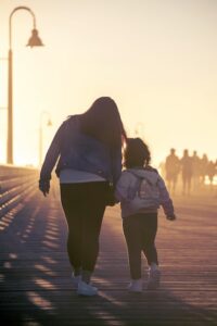 A mãe e a filha a caminhar num cais