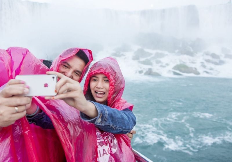 People taking a selfie on the Voyage to the Falls Boat Tour