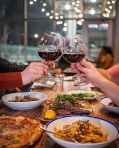 Wine glasses cheered over steak dinner