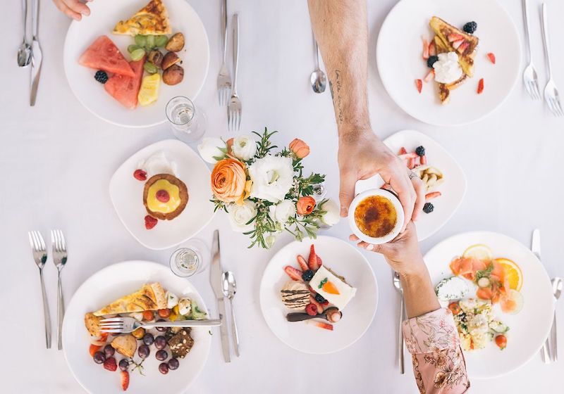 Brunch food hands reaching across table