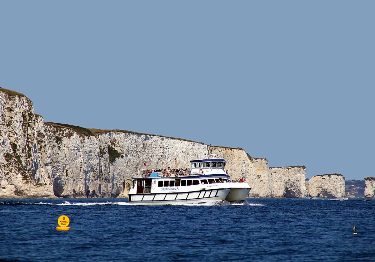 Boat in Poole, United Kingdom in front of the Jurassic Coast