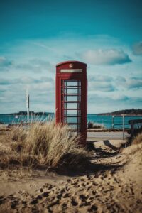 cabina telefonica inglese rossa sulla spiaggia