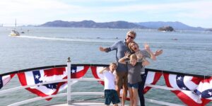 Family on deck of boat San Francisco Bay in background