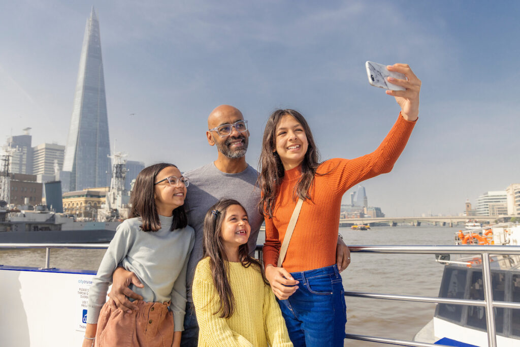 family taking sightseeing selfie in london