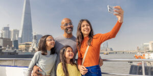 family taking sightseeing selfie in london