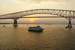 Ship at sunset bridge in background