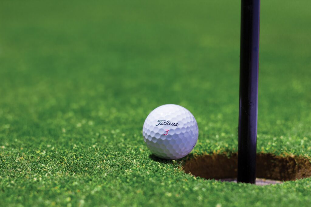 golf ball next to the pin