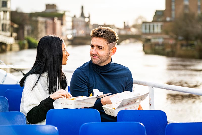 guests enjoying fish and chips on york city cruise