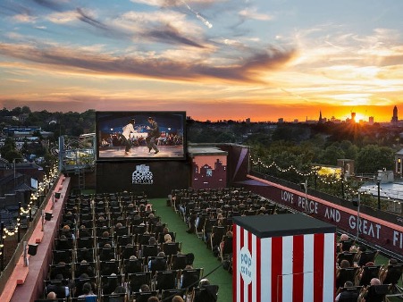 people watching a movie outdoors at the rooftop film club