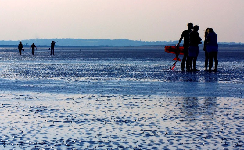 people walking on the beach at camber sands