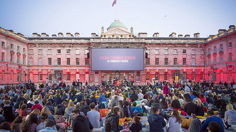 people watching a movie outdoors at somerset house