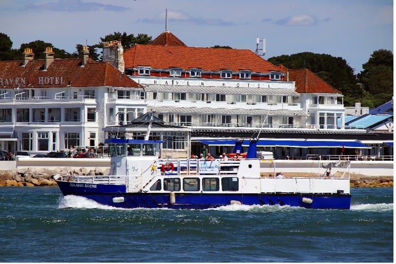 poole ity cruises vessel sailing in front of the haven hotel