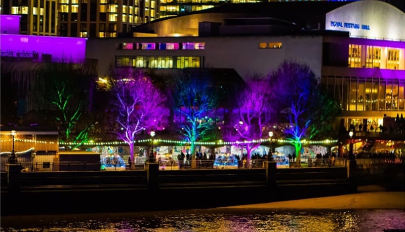 riverfront christmas markets lit up at night