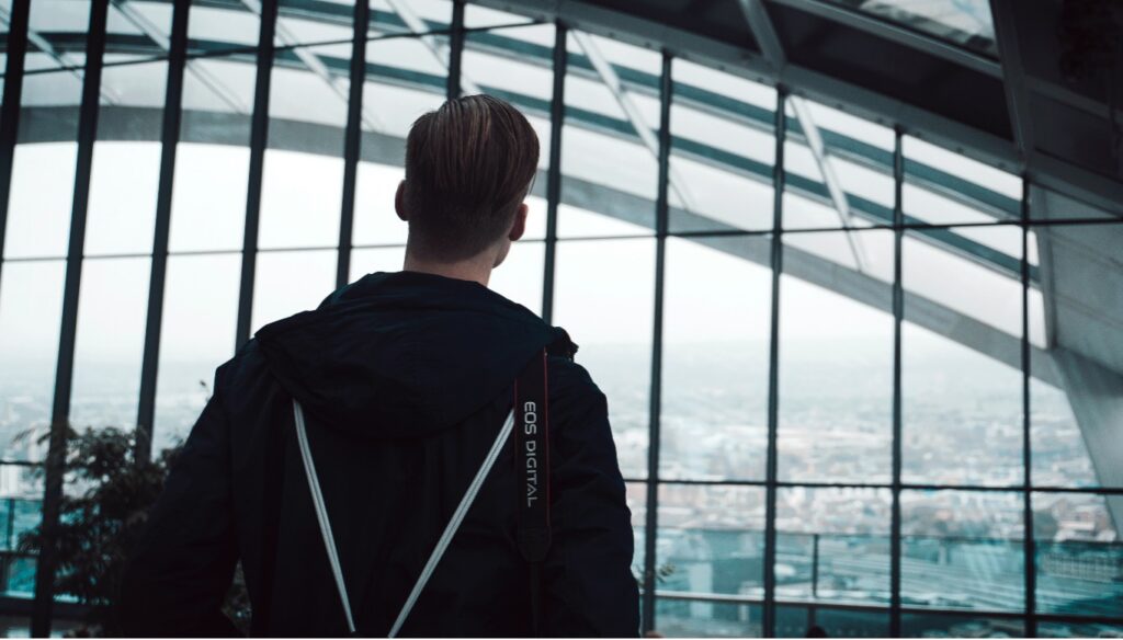 man looking out at the city from the sky garden